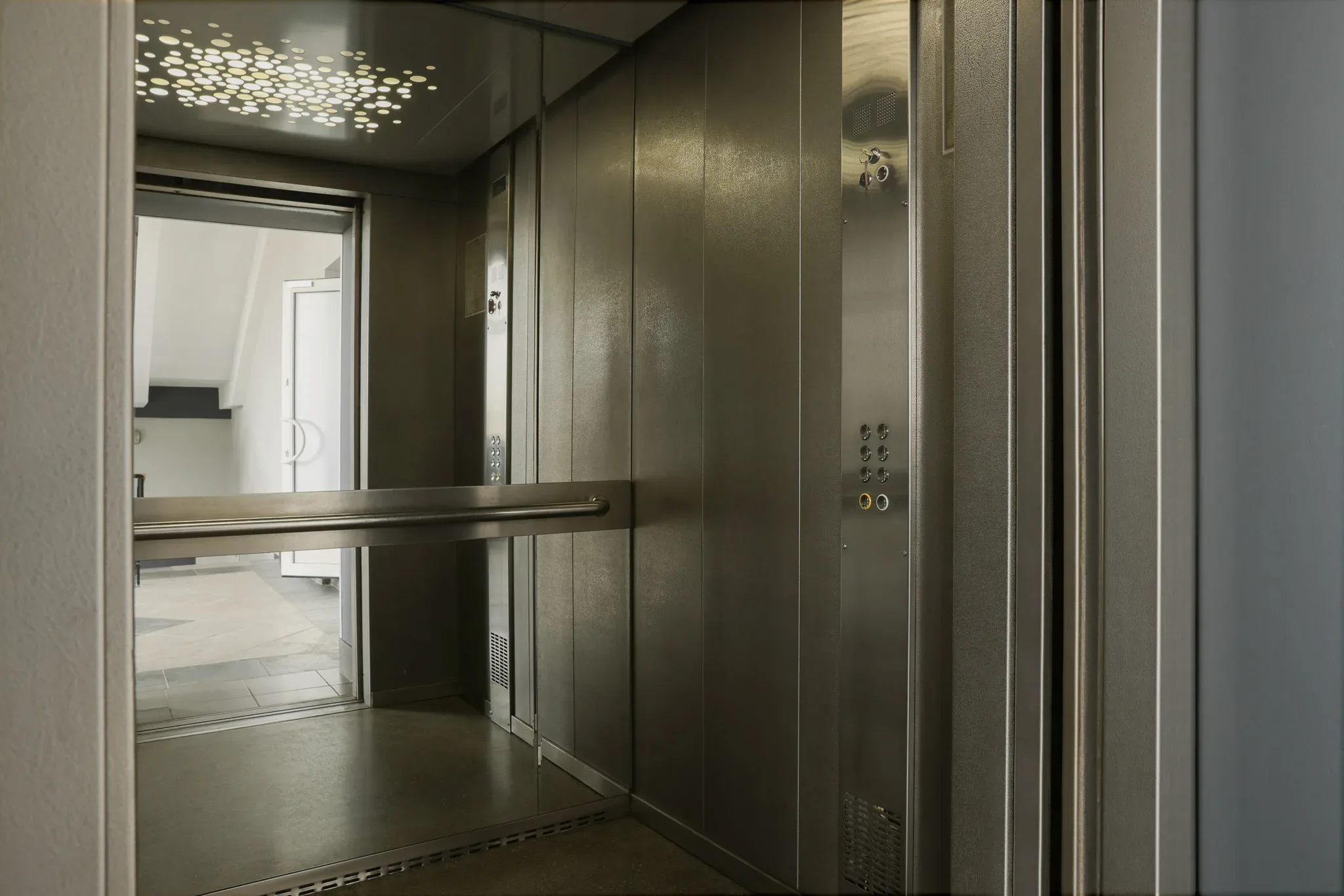 Open,Elevator`s,Cabin,With,Big,Mirror,Indoors A 3d model of an elevator in a building.